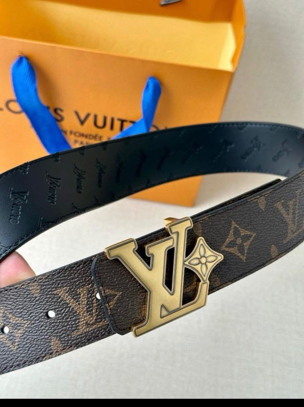 Louis Vuitton reversible belt, such as the Pretty LV or LV Initiales model