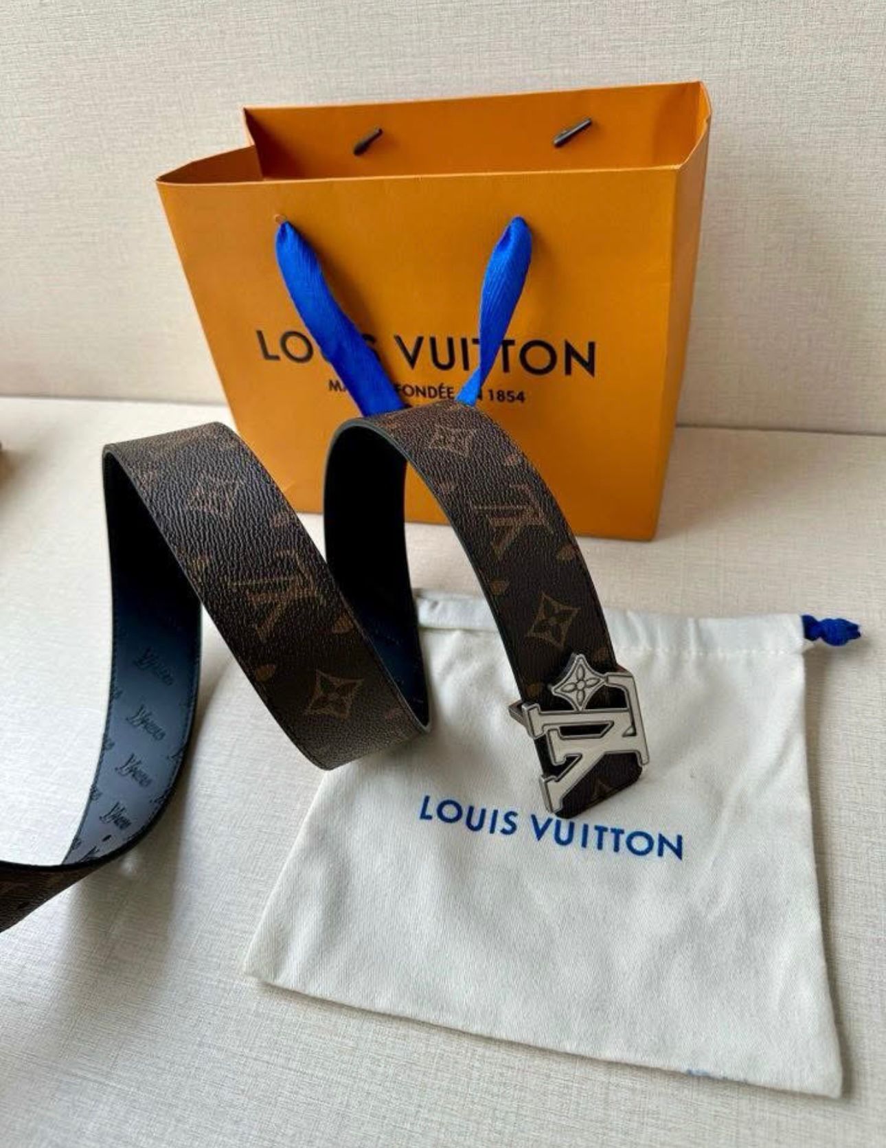 Louis Vuitton reversible belt, such as the Pretty LV or LV Initiales model