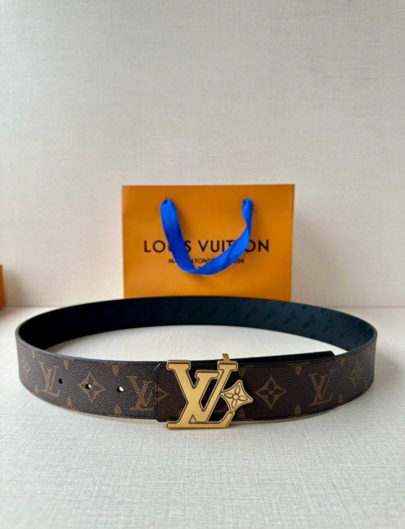 Louis Vuitton reversible belt, such as the Pretty LV or LV Initiales model