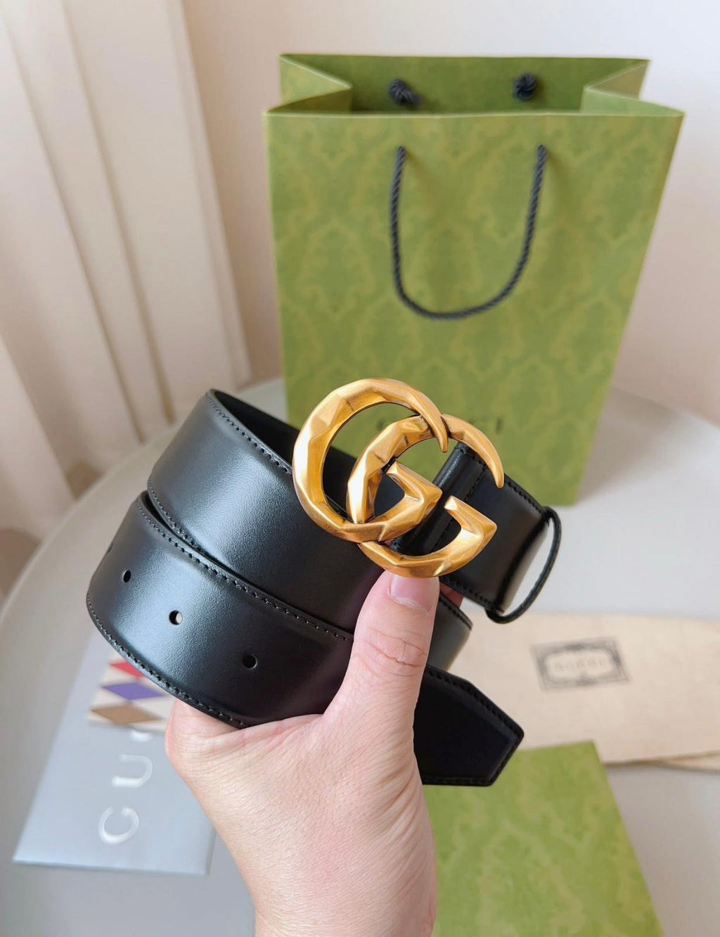 Gucci GG Marmont black leather belt with an aged gold-toned G buckle