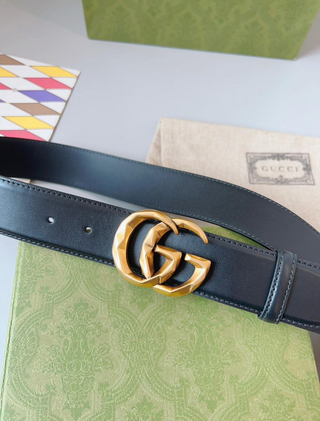 Gucci GG Marmont black leather belt with an aged gold-toned G buckle